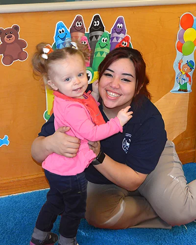 Daycare Careers at Northern Virginia Academy of Early Learning - Join Our Team! Happy employee hugging cute child