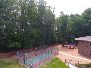 Northern Virginia Academy of Early Learning Burke Campus - aerial image of basketball court with partial view of playground