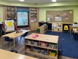 Northern Virginia Academy of Early Learning Burke Campus - three year old room with bulletin board and supplies stations