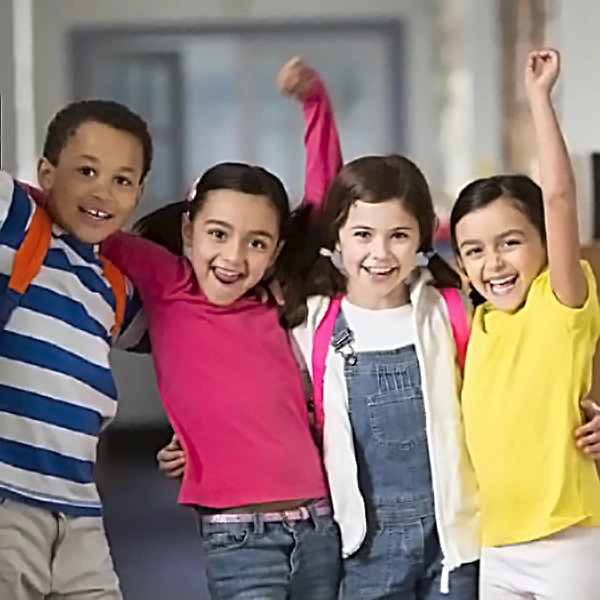 Before and After School Care at Northern Virginia Academy of Early Learning - group of school age children smiling and looking triumphant with arms in the air