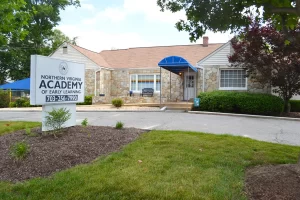Northern Virginia Academy - Lincolnia Campus - Front Exterior of stone building with blue awning
