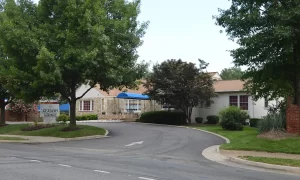 Northern Virginia Academy - Lincolnia Campus - Front exterior of stone building, blue awning, and landscaping