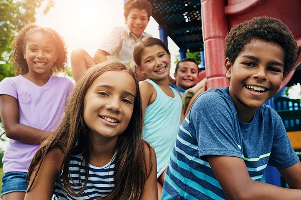 Before and After School Program - Northern Virginia Academy of Early Learning - group of school age children on playground together.