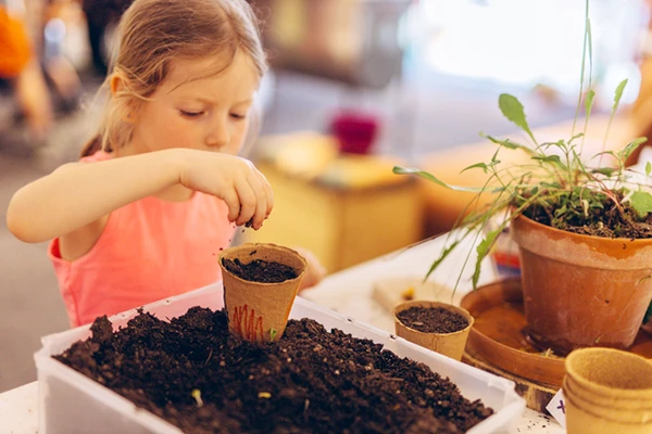 Montessori School in Burke VA - Northern Virginia Academy of Early Learning - young girl potting plants