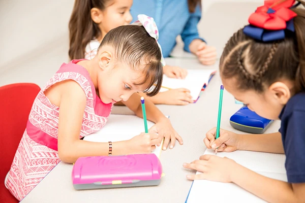 Preschool for Four Year Olds - Northern Virginia Academy of Early Learning - children writing together at table