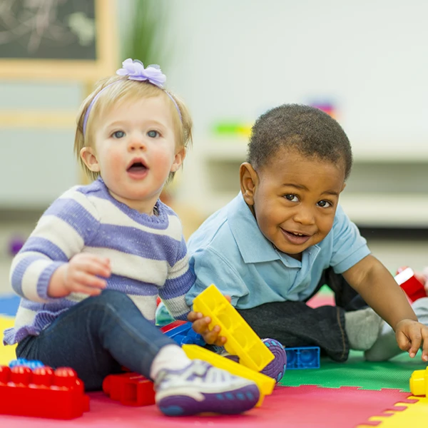 Toddler Care - Northern Virginia Academy of Early Learning - smiling children playing together with toys